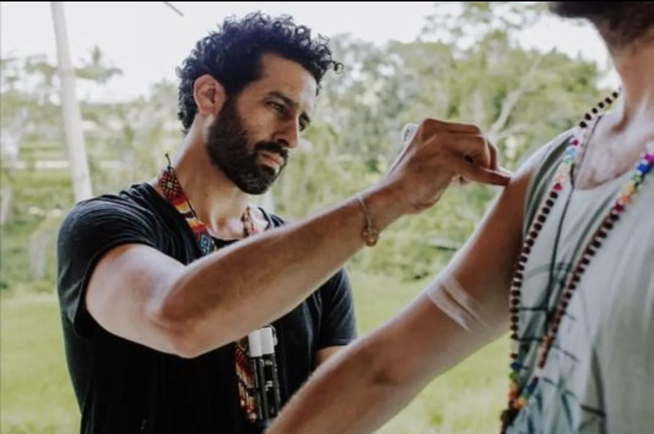 Amir Magal sharing a creative body-painting tradition outdoors