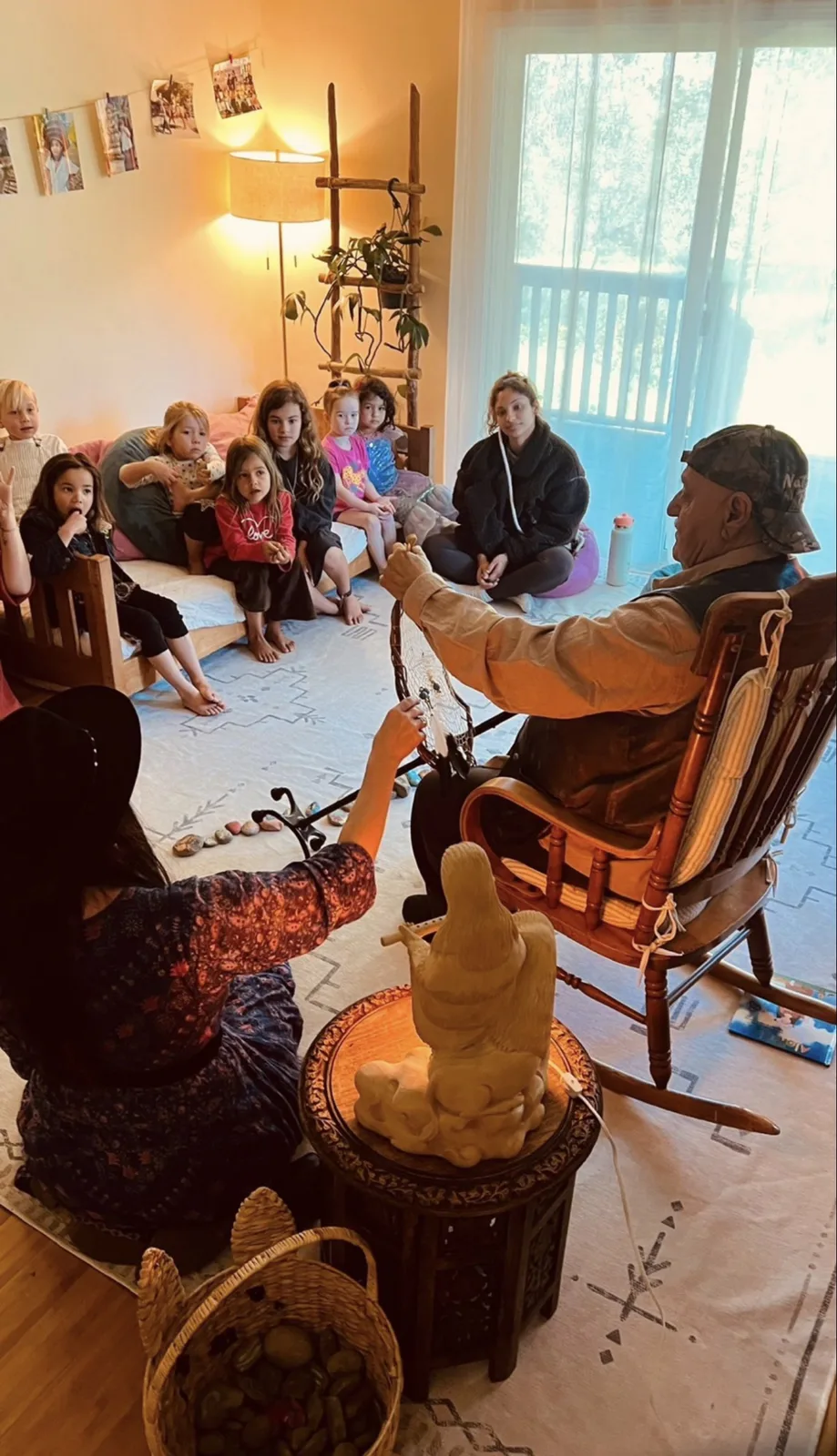 Children gathered as a visiting elder shares dreamcatcher traditions