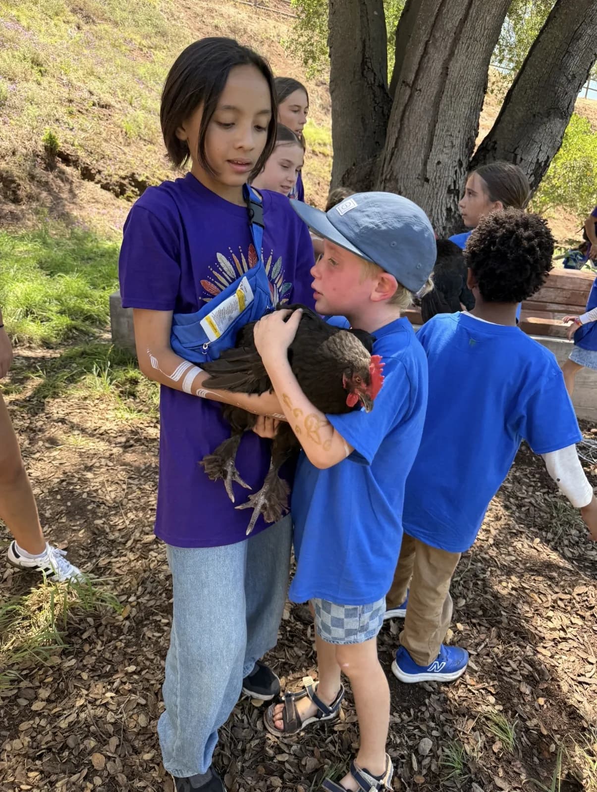 A child sharing a close moment with a chicken
