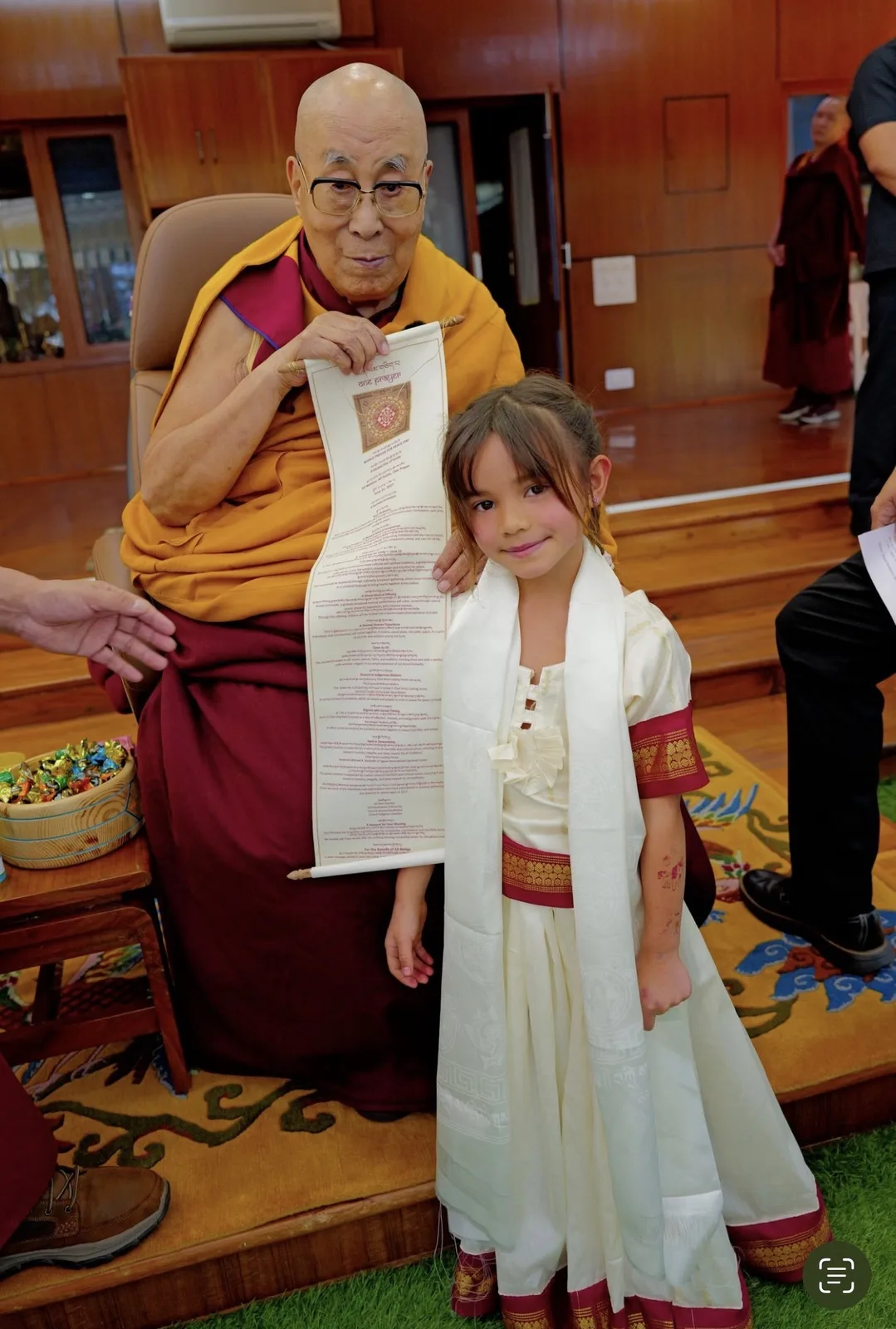 A child meeting a respected Buddhist elder during a cultural journey