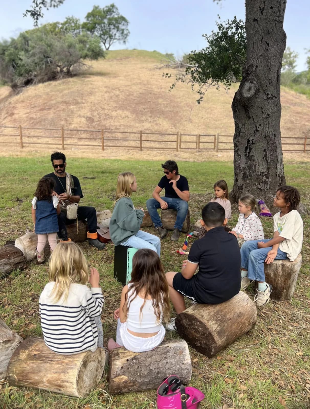 Children listening together in an outdoor learning circle