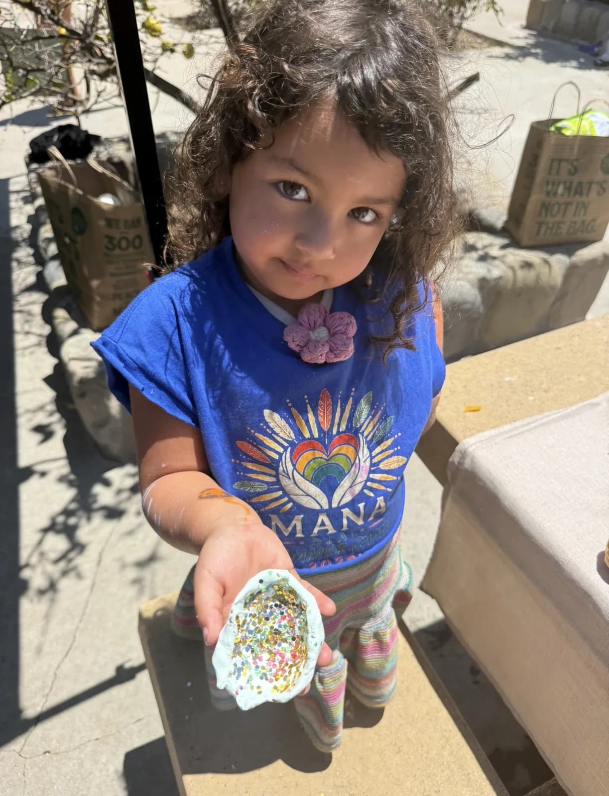 A child showing a hand-painted object