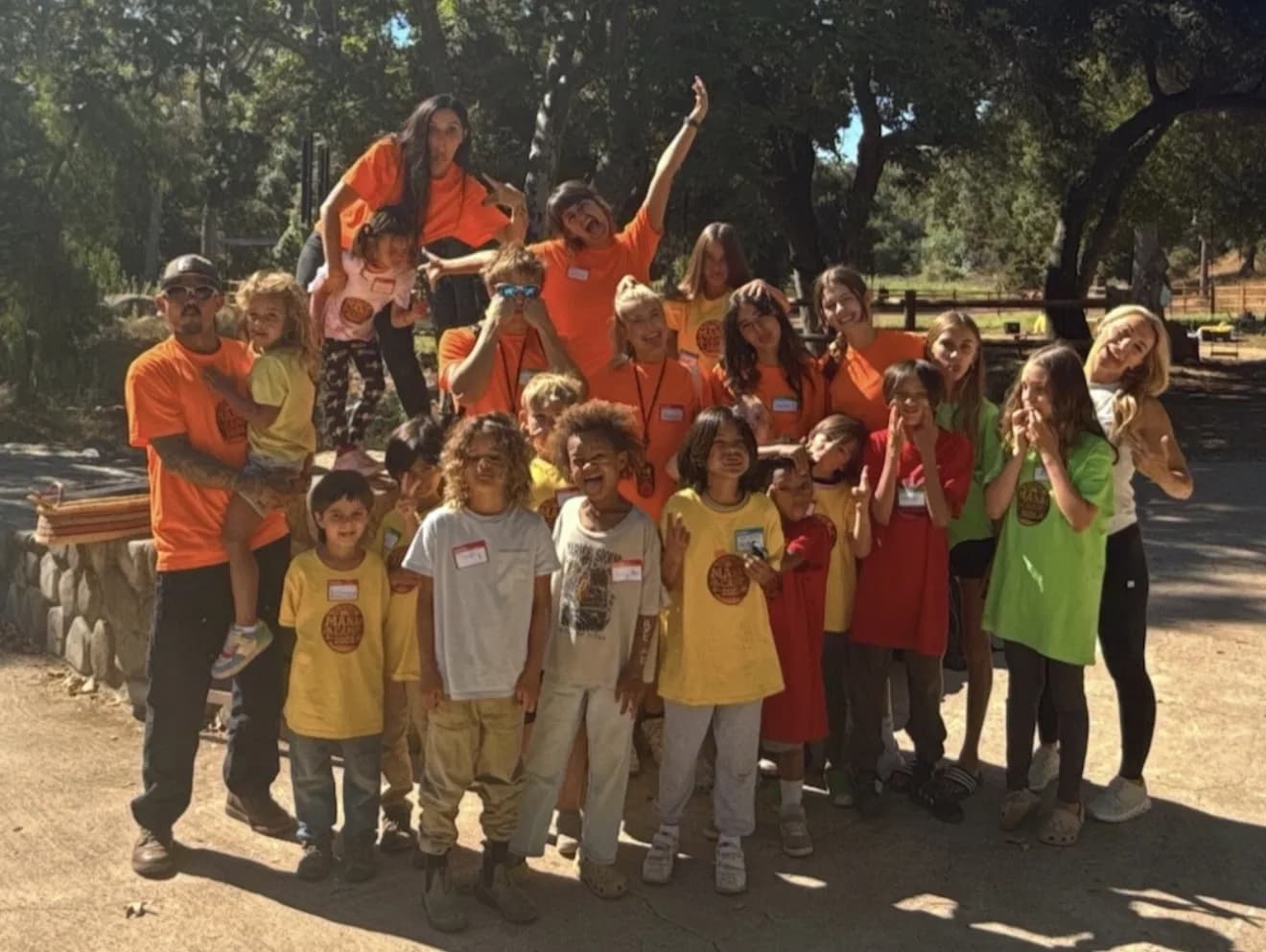 A joyful MANA summer group gathered beneath the trees