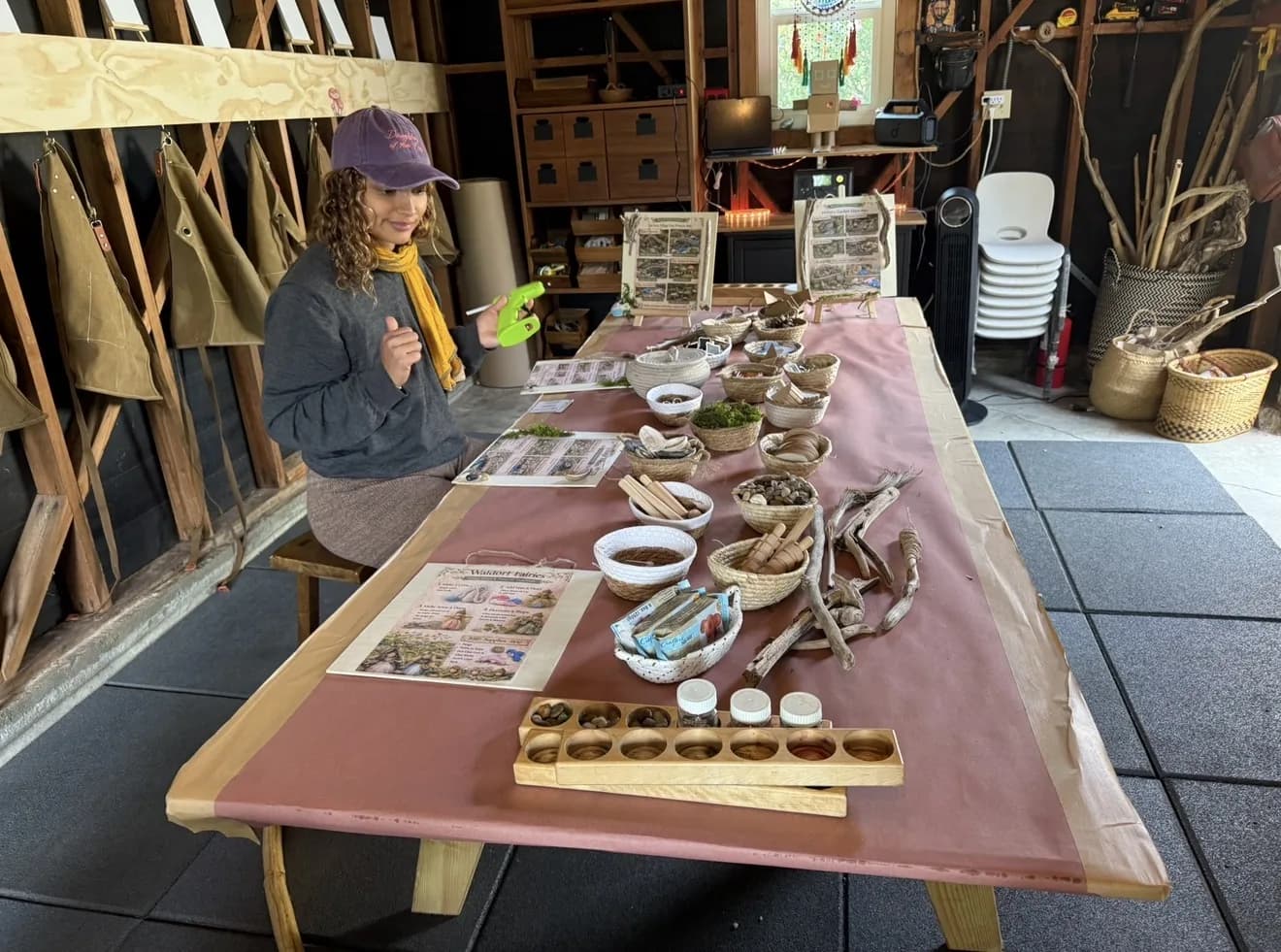 A guide standing beside a carefully prepared makers station